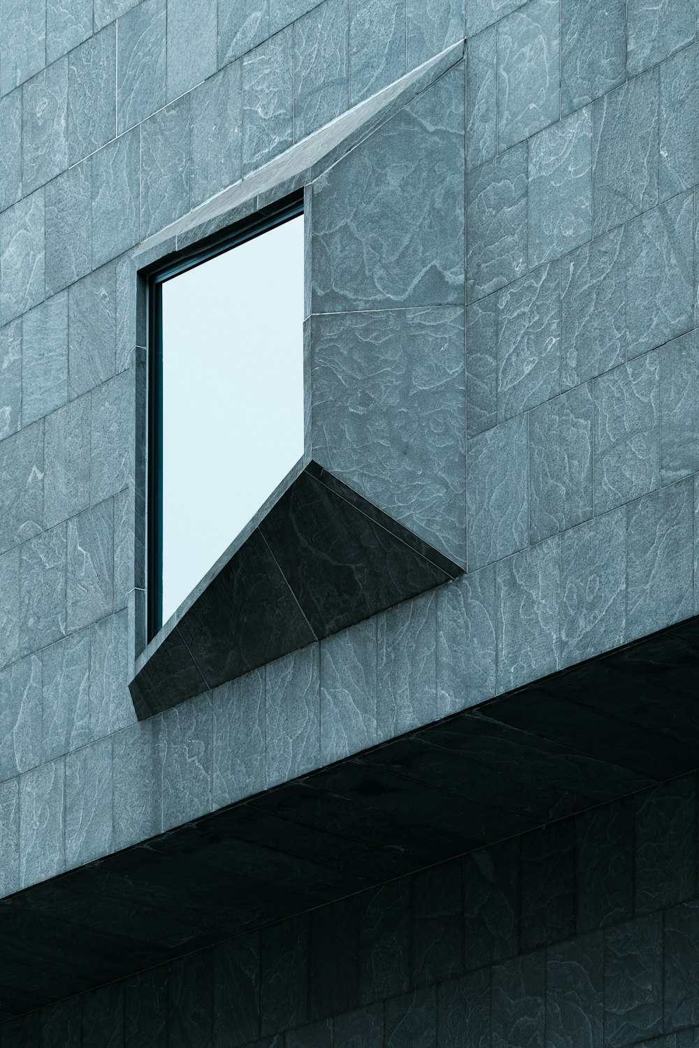 a corner of a building with a window on it