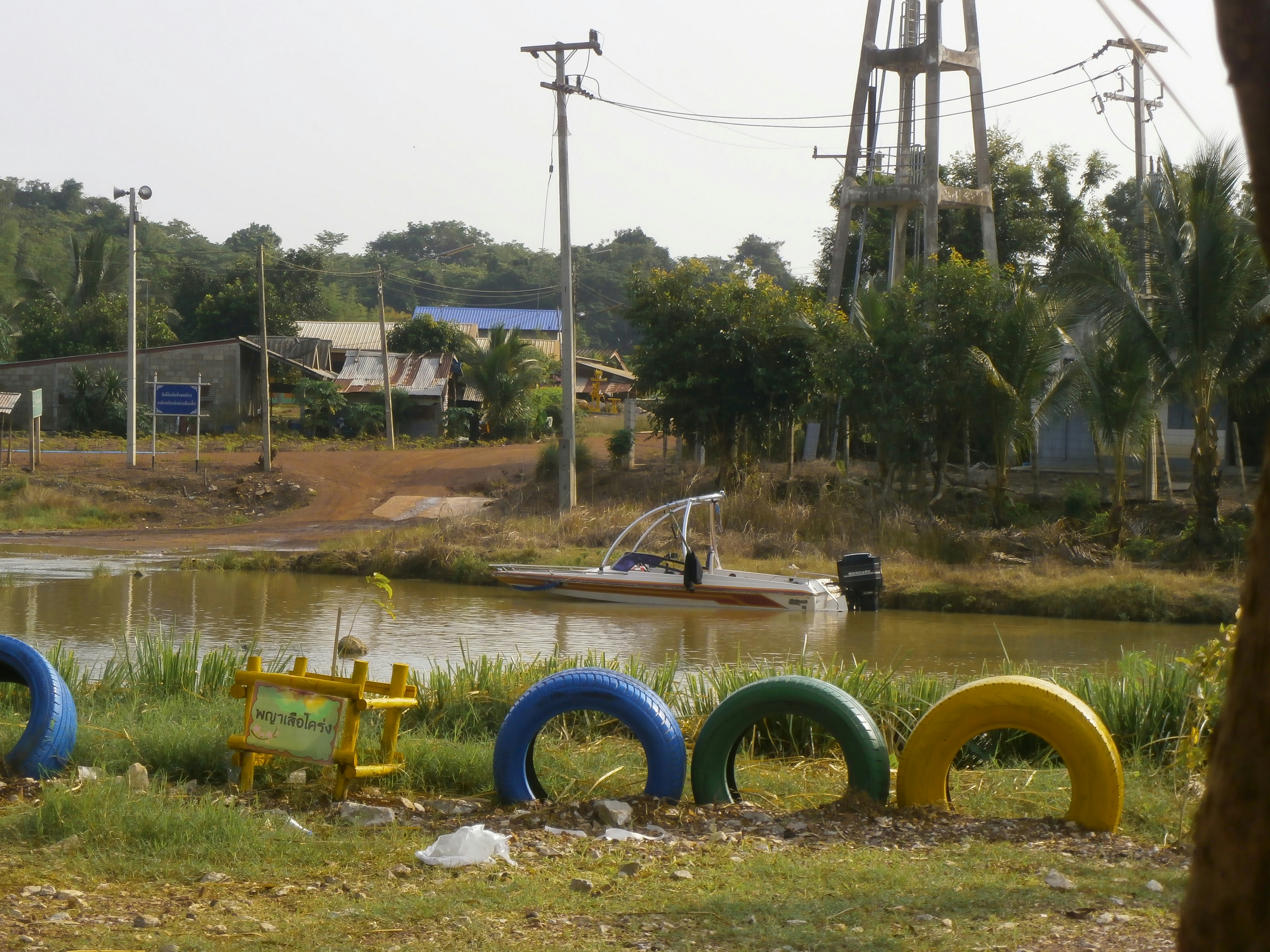 a row of colorful plastic toys sitting next to a river