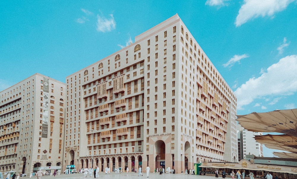 a group of people standing in front of a tall building