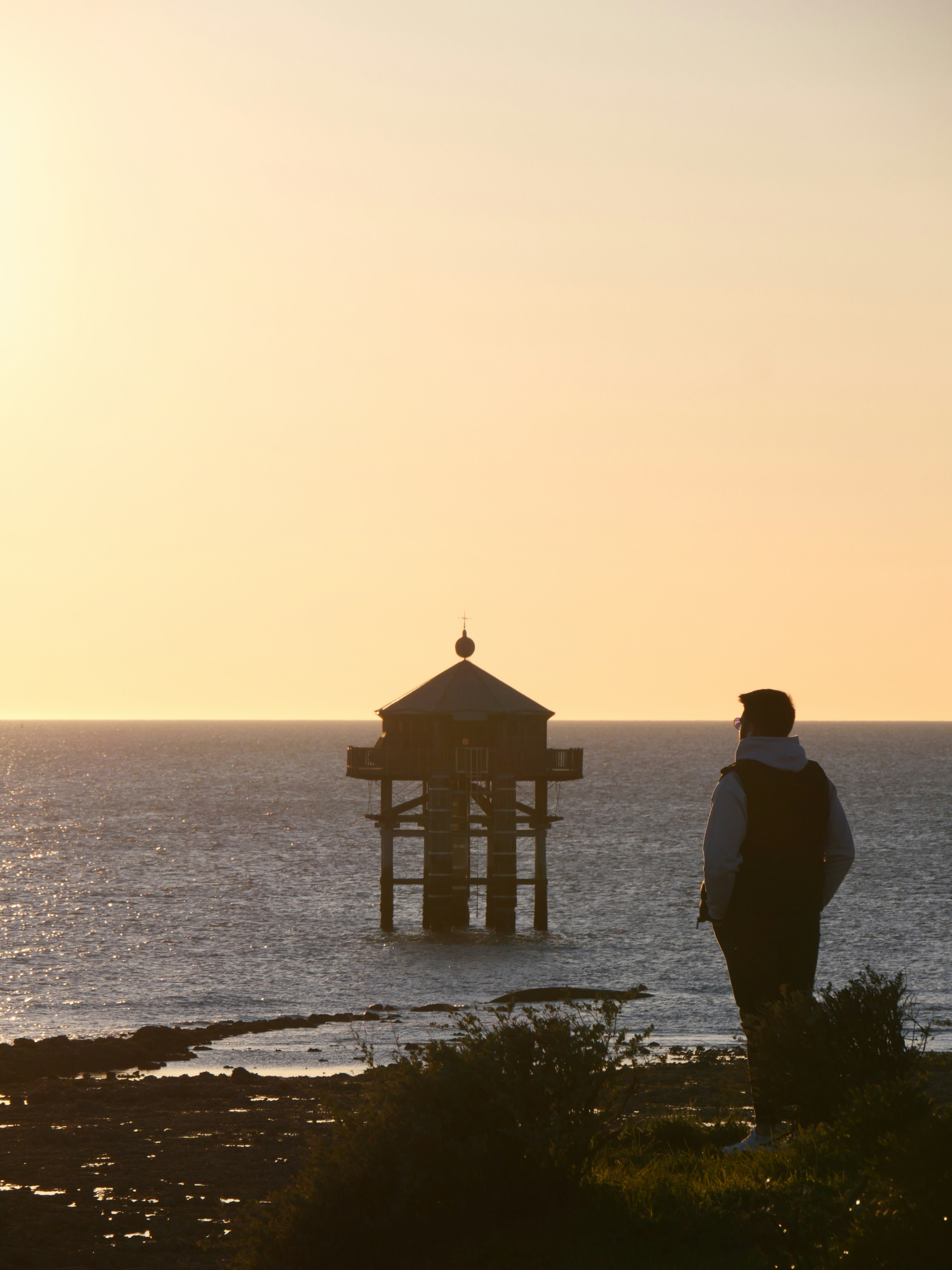 a couple of people standing on top of a beach