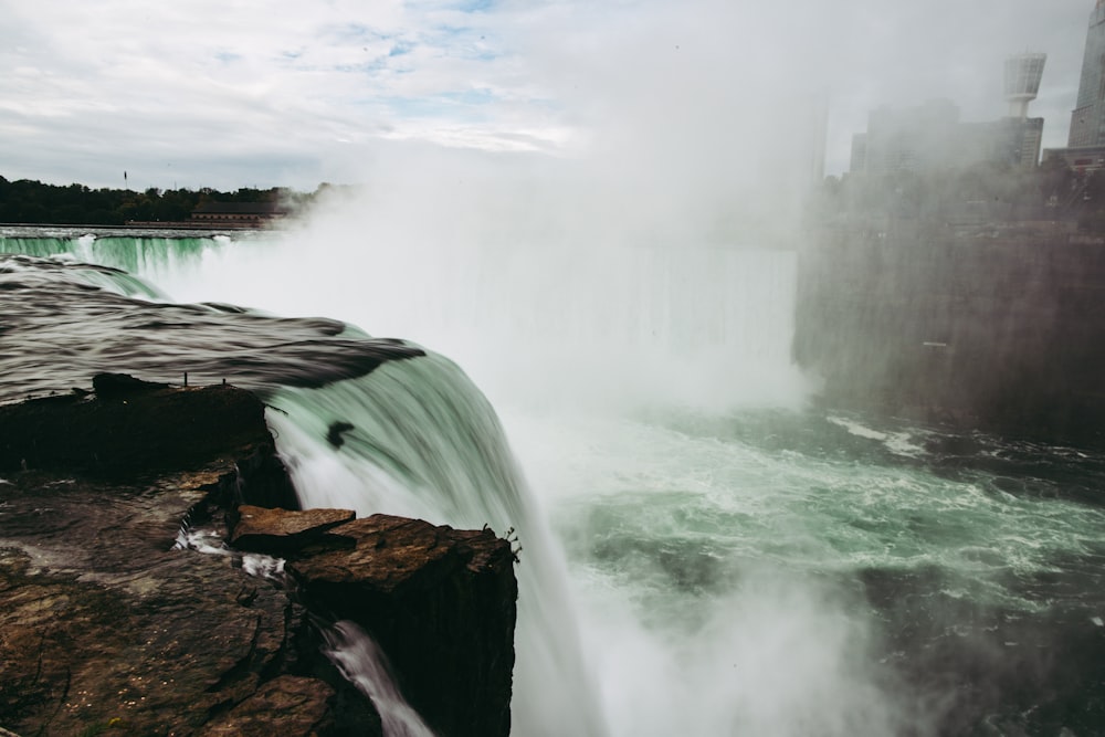 a large waterfall with water gushing out of it