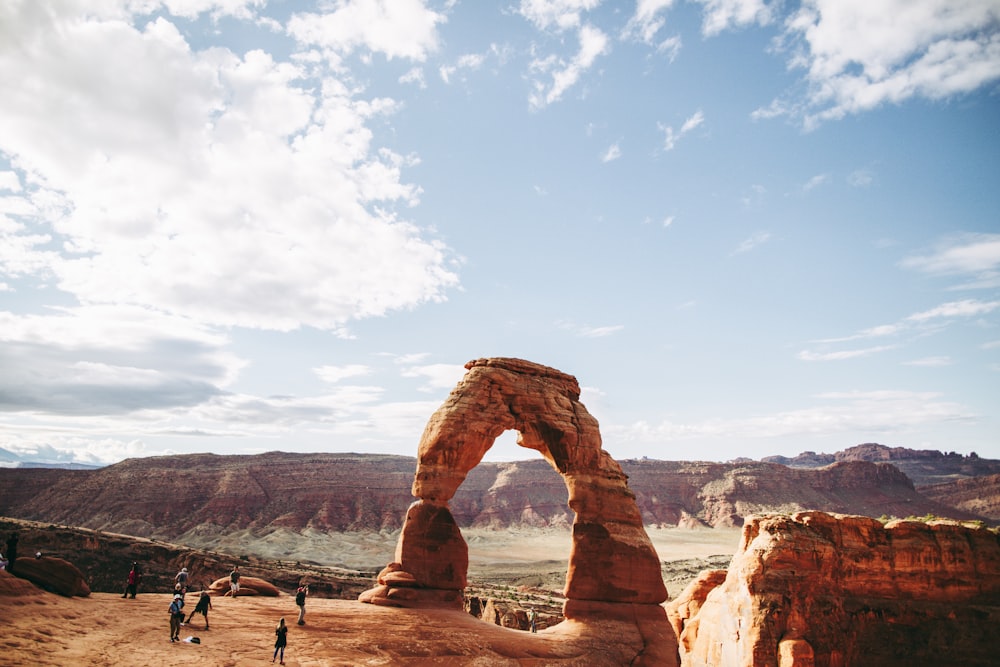 a group of people standing on top of a desert