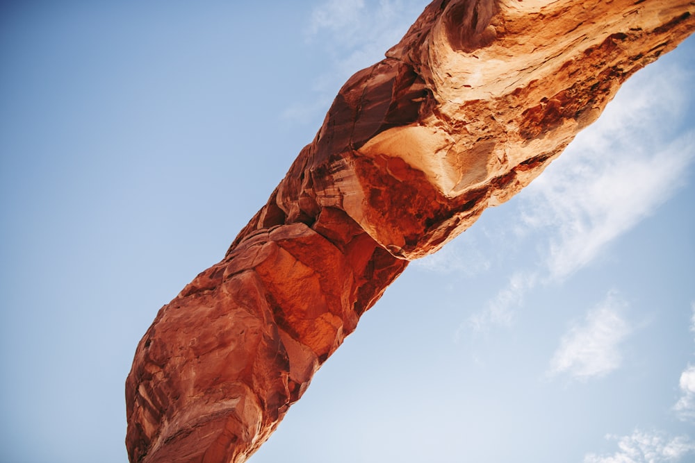 a very tall rock formation with a sky in the background