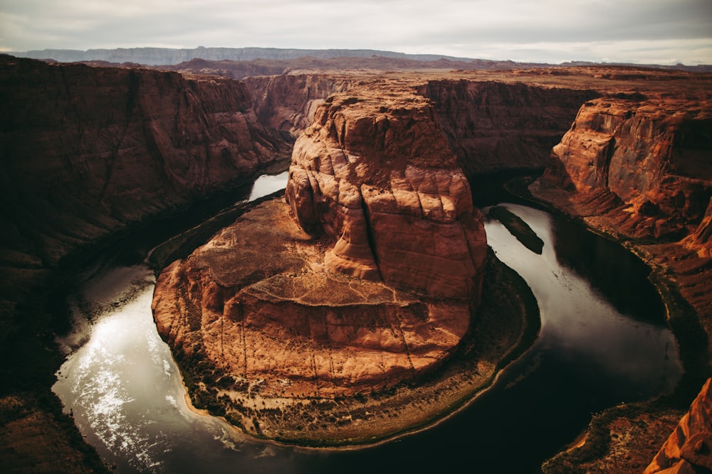 a river cuts through a canyon in the desert