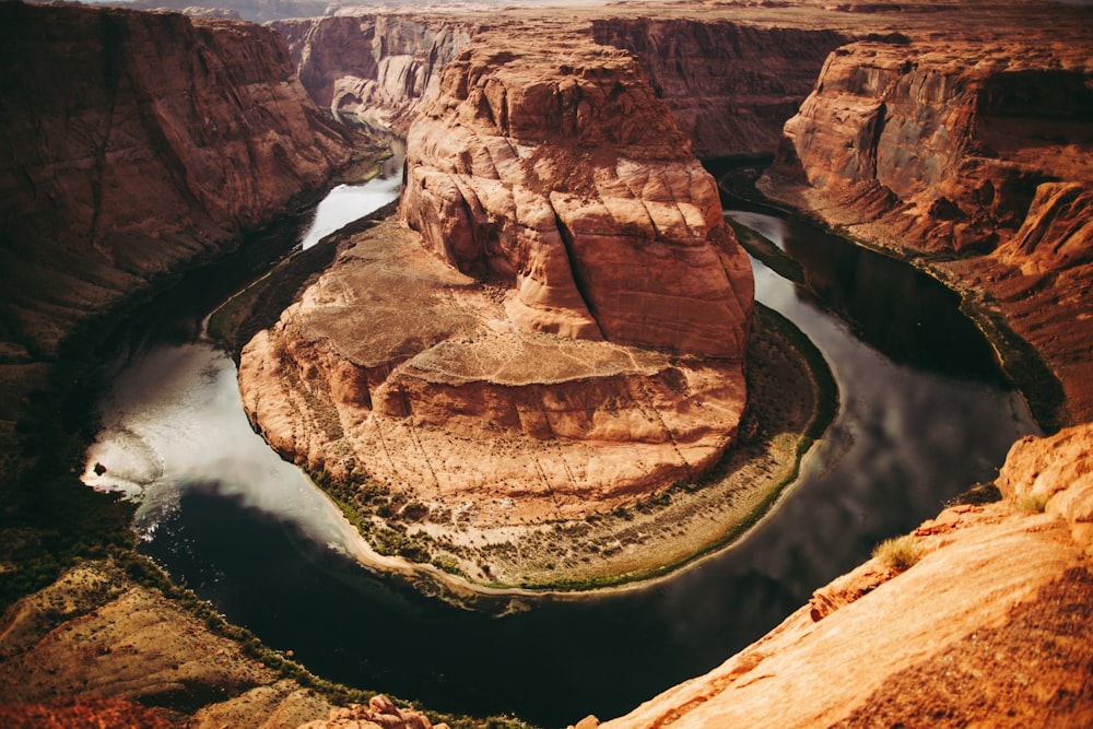 a river flowing through a canyon surrounded by mountains