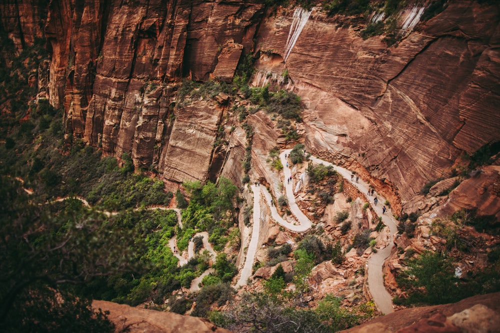 a scenic view of a winding road in the mountains