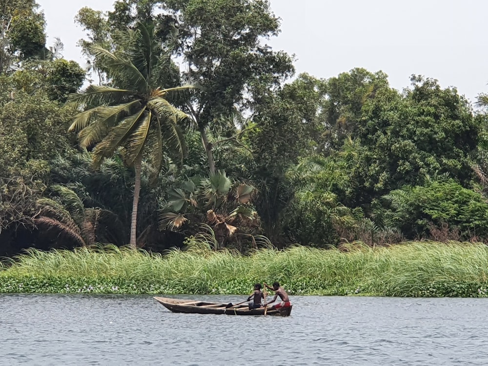 two people in a small boat on a river