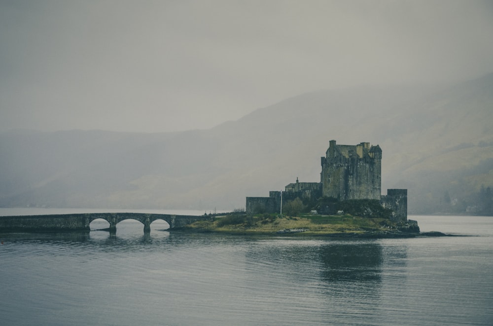 a castle sitting on a small island in the middle of a lake