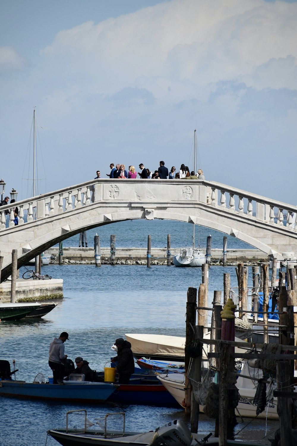 a group of people on a bridge over a body of water