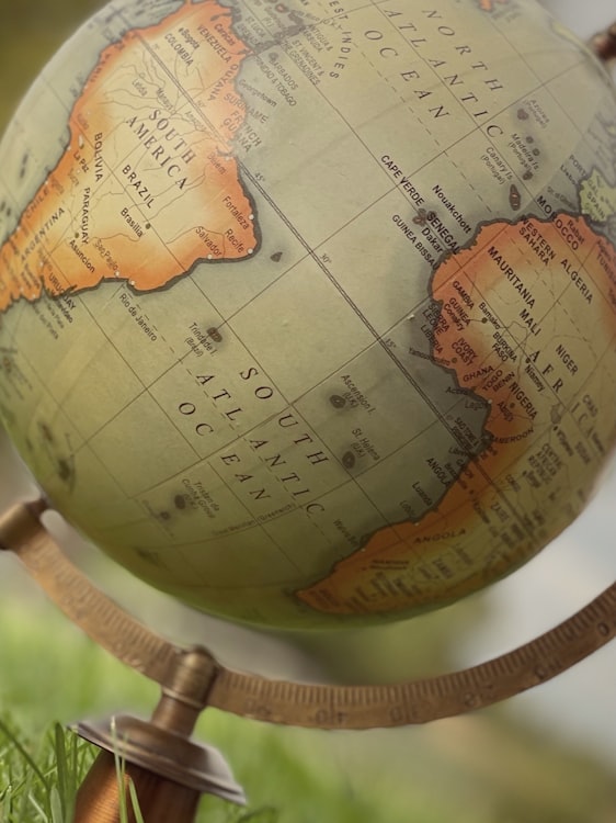 A world map with pins marking travel destinations