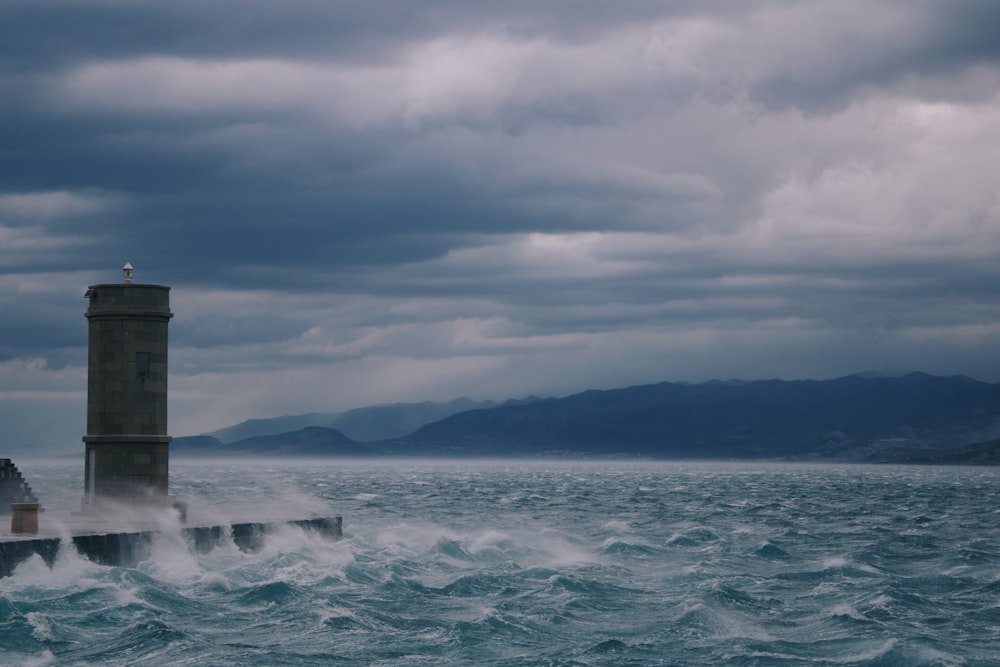 a lighthouse in the middle of a large body of water