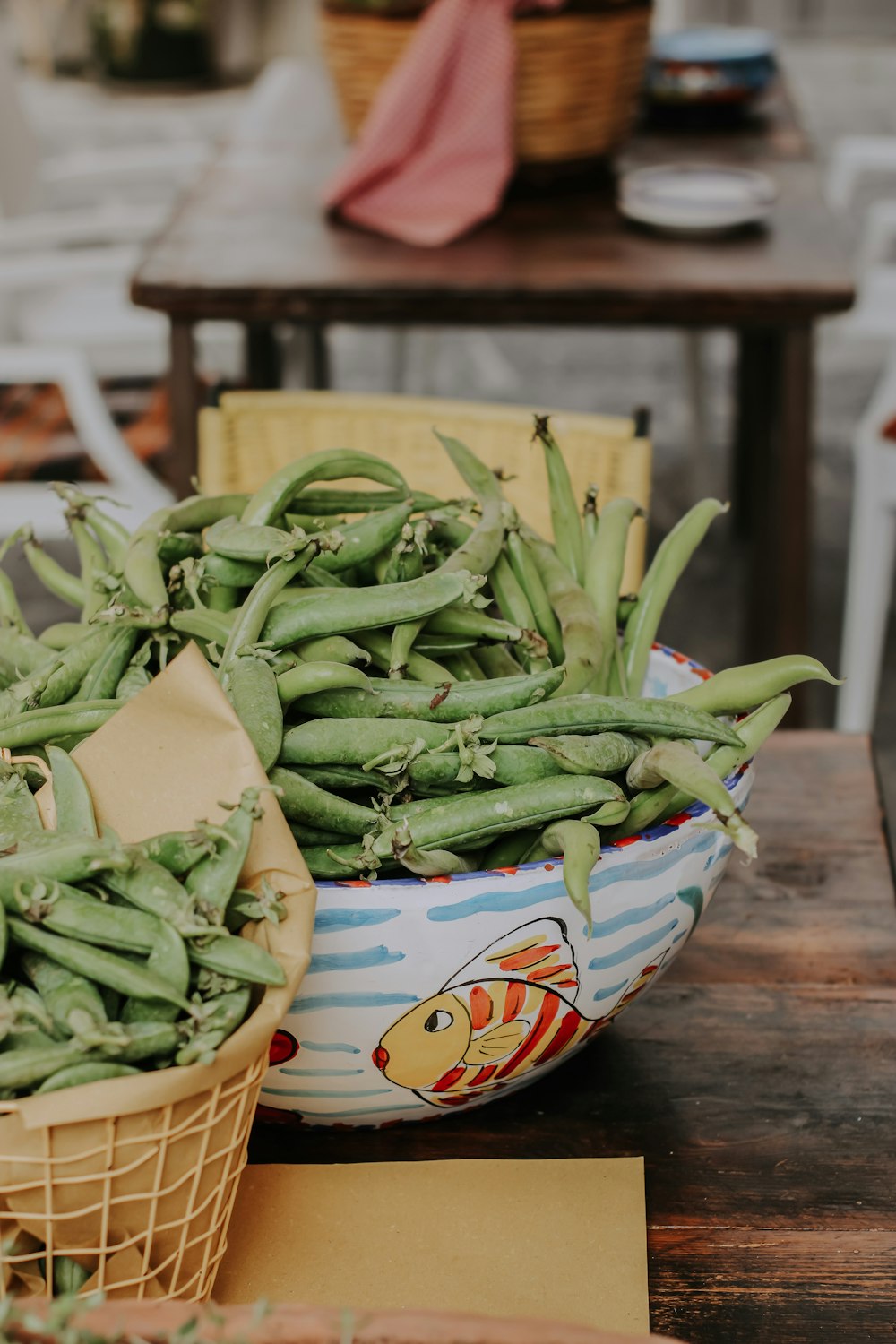 a bowl full of green beans sitting on a table