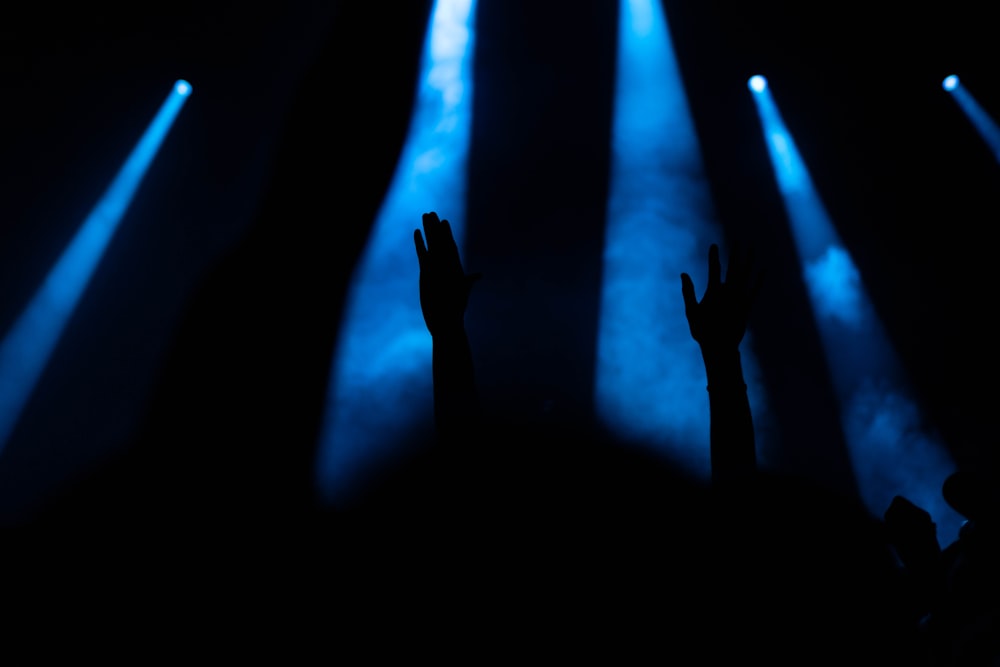 a group of people that are standing in the dark