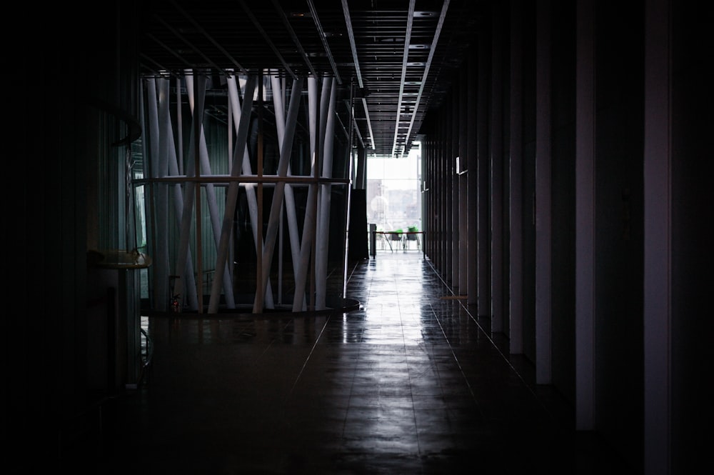 a dark hallway with a light at the end of it