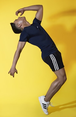 a man in a blue shirt and black shorts