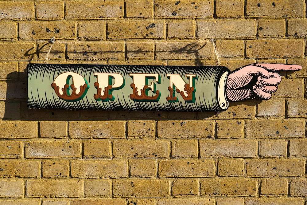 a brick wall with a sign that says open on it