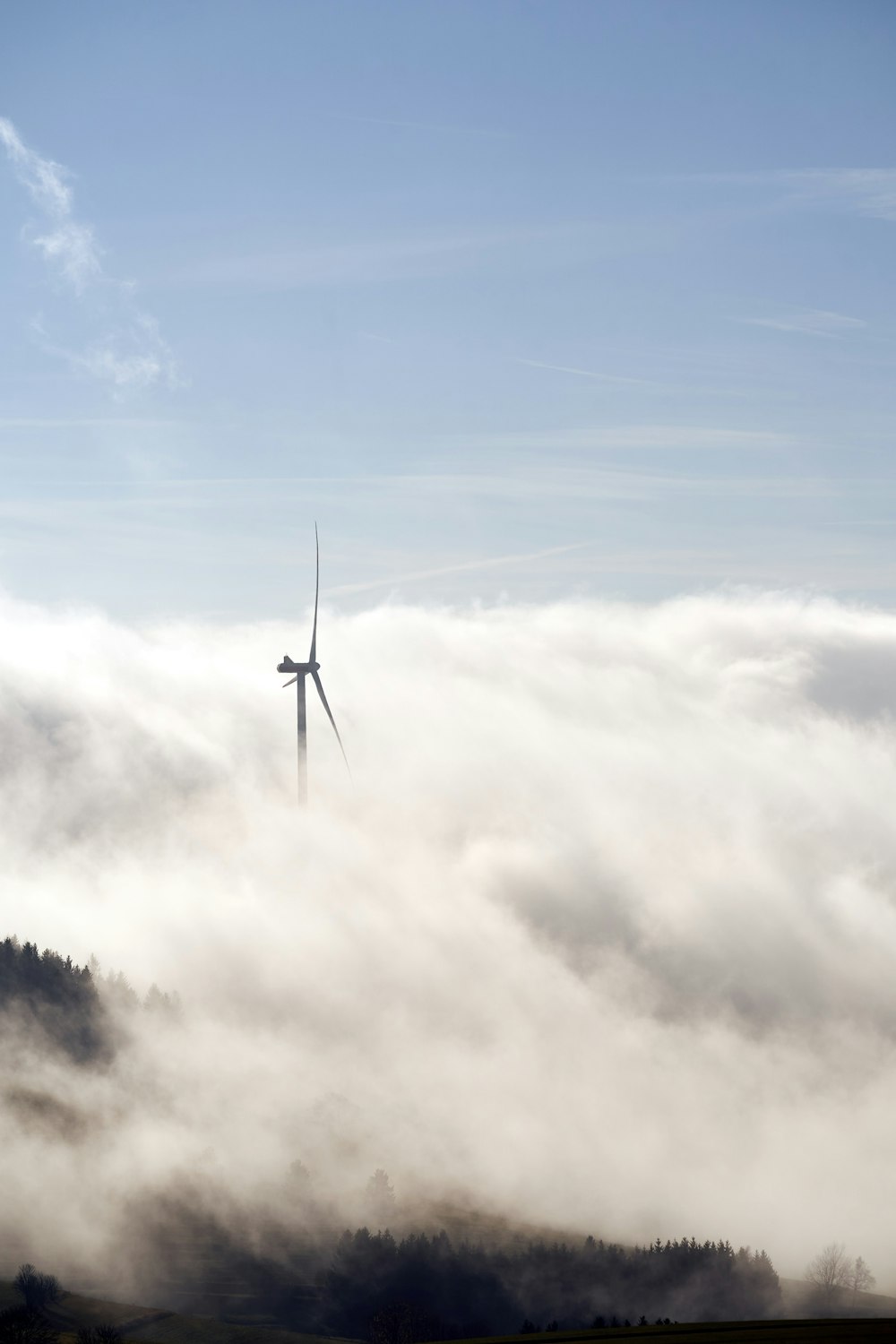 a wind turbine in the middle of a foggy field