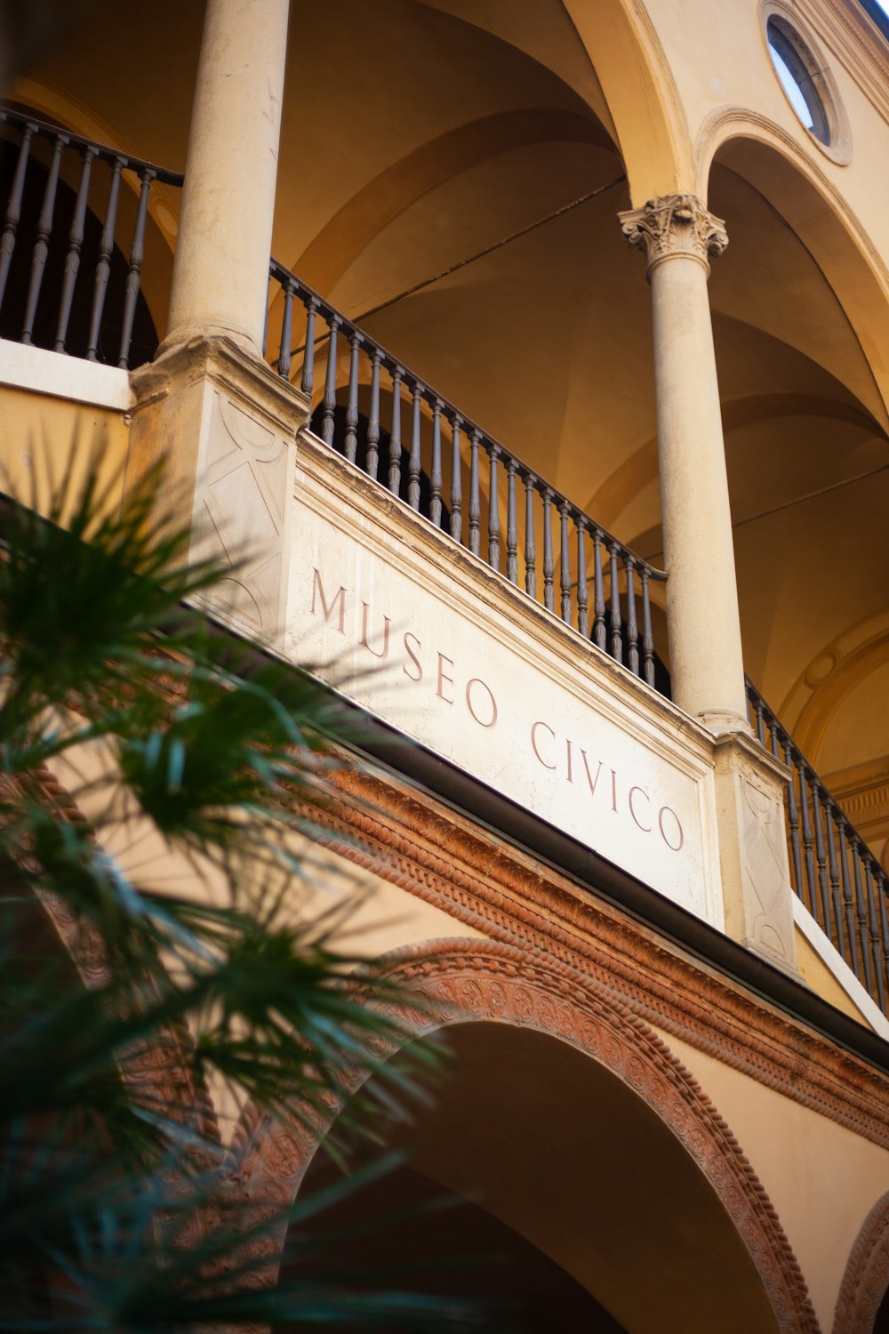 a building with a balcony and a sign on the front of it