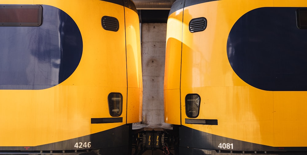 two yellow and black trains side by side