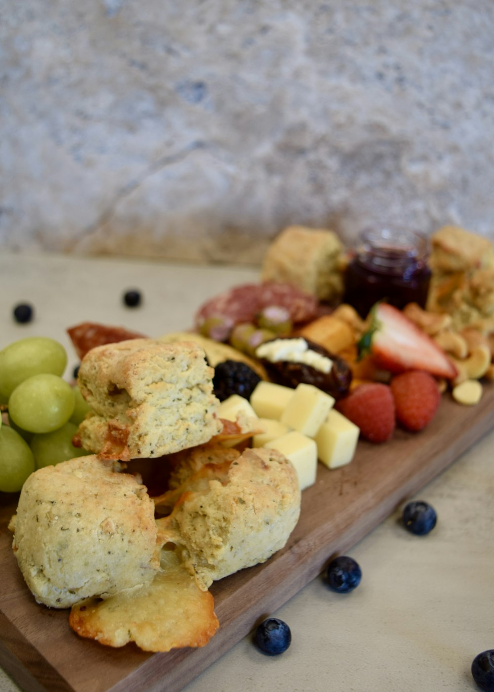 a wooden cutting board topped with different types of food