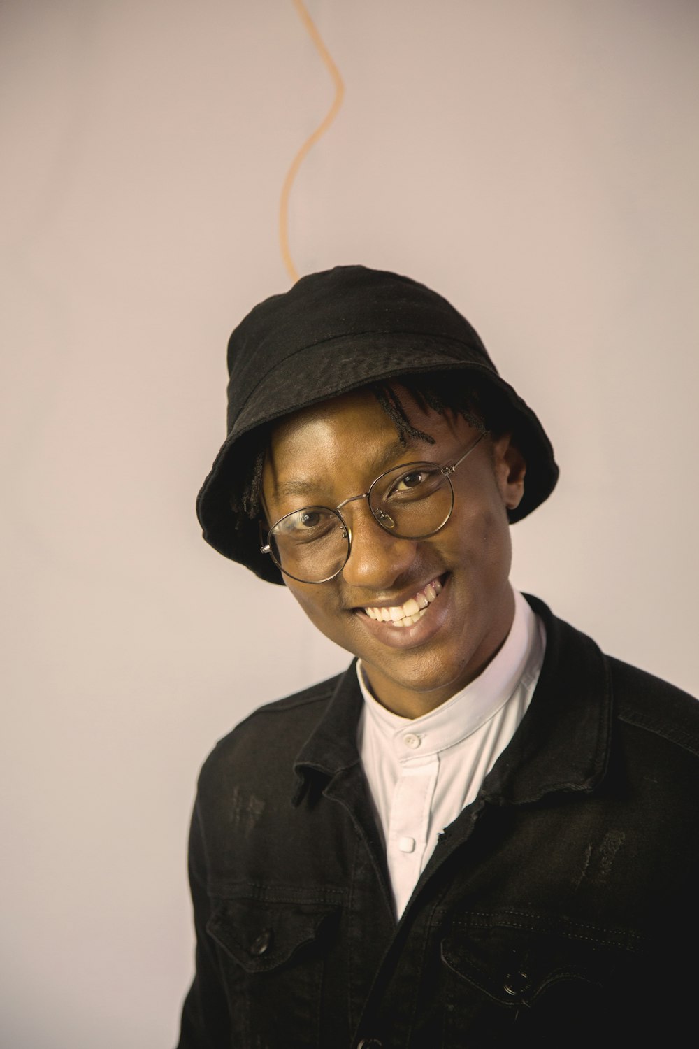 a man wearing a black hat and glasses