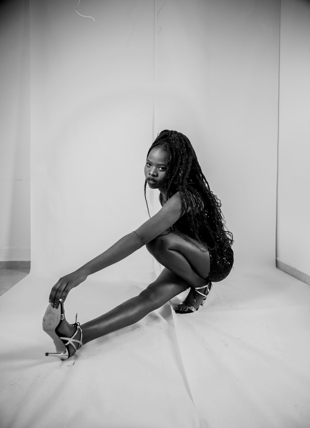 a woman sitting on the floor with her legs crossed