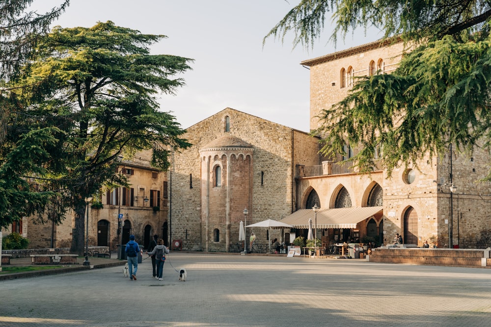 a couple of people walking down a street