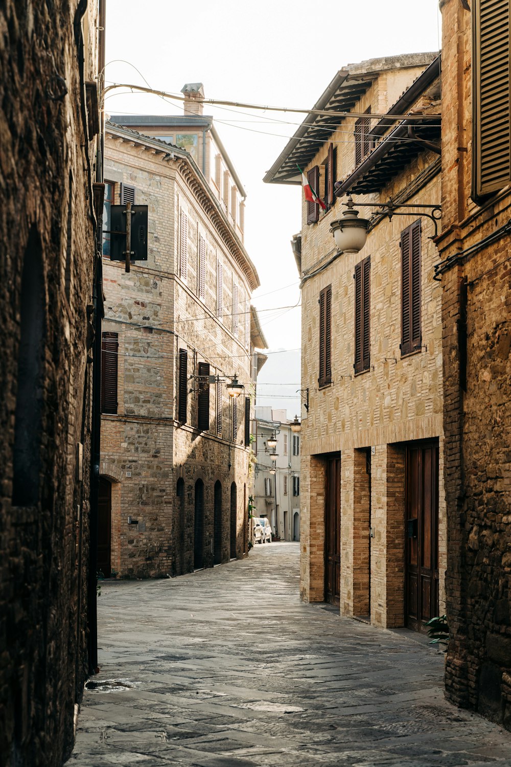 a cobblestone street lined with stone buildings