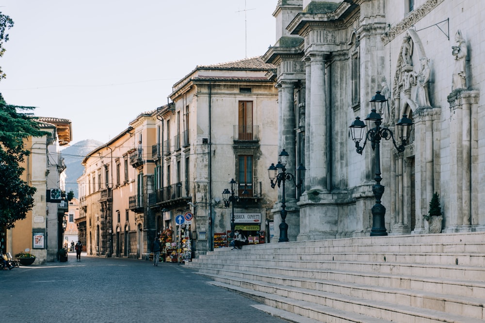 a city street lined with tall buildings and stone steps