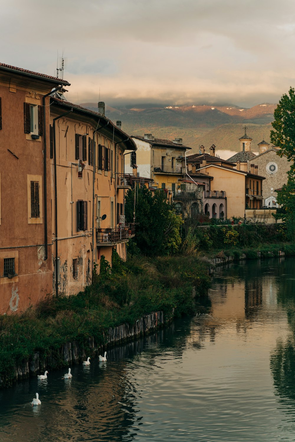 a body of water next to a row of buildings