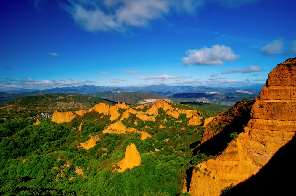 a scenic view of a mountain range with a blue sky