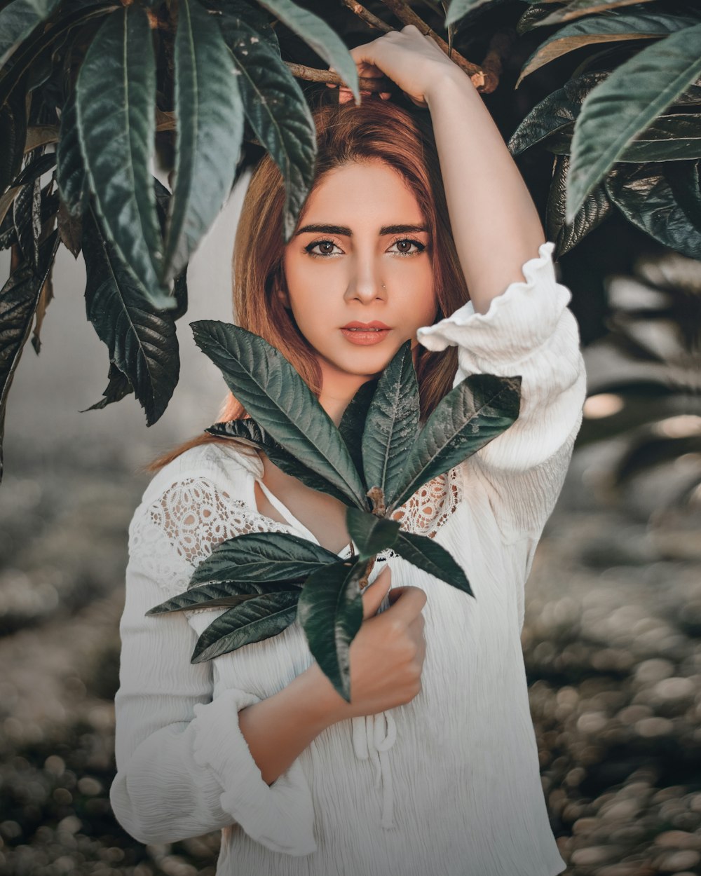 a woman holding a plant in front of her face