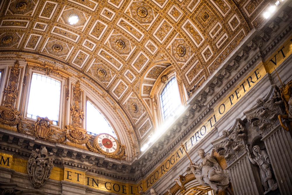 the ceiling of a building with gold and white designs