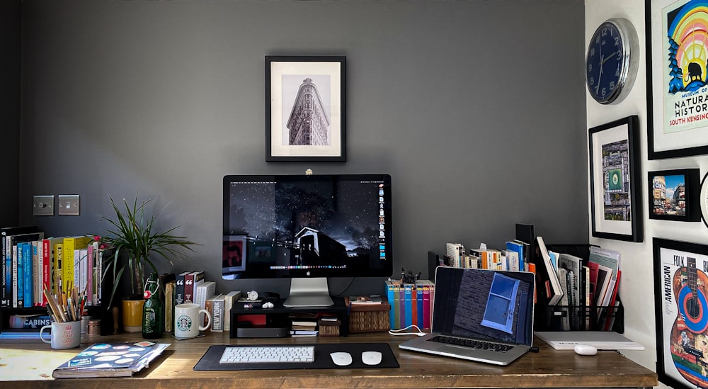 a desk with a computer and a laptop on it