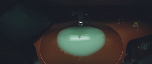 Artistic angle of a bathroom sink area highlighted by bold orange colors.