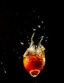 A splash of bright pop stream soda pouring into a glass, capturing the fizz and bubbles mid-air.