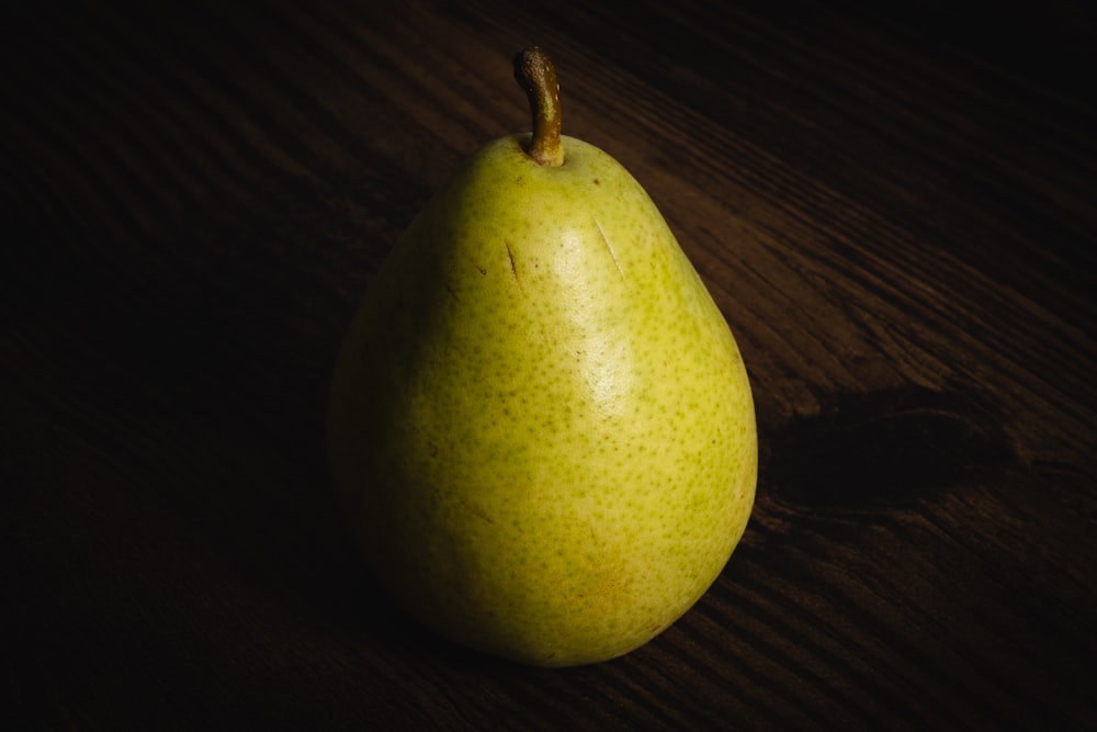a pear sitting on top of a wooden table