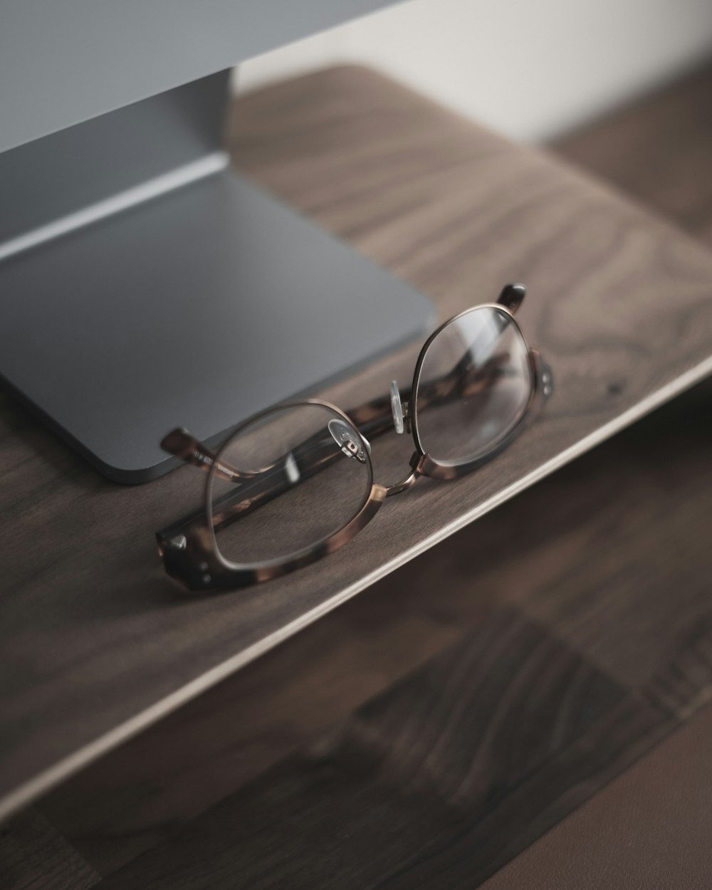 a pair of glasses sitting on top of a wooden table