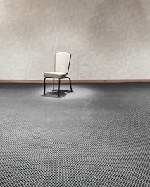a chair sitting in a room next to a wall