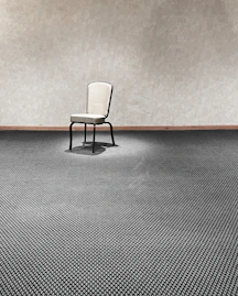a chair sitting in a room next to a wall