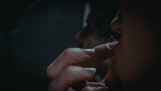 a woman smoking a cigarette in the dark