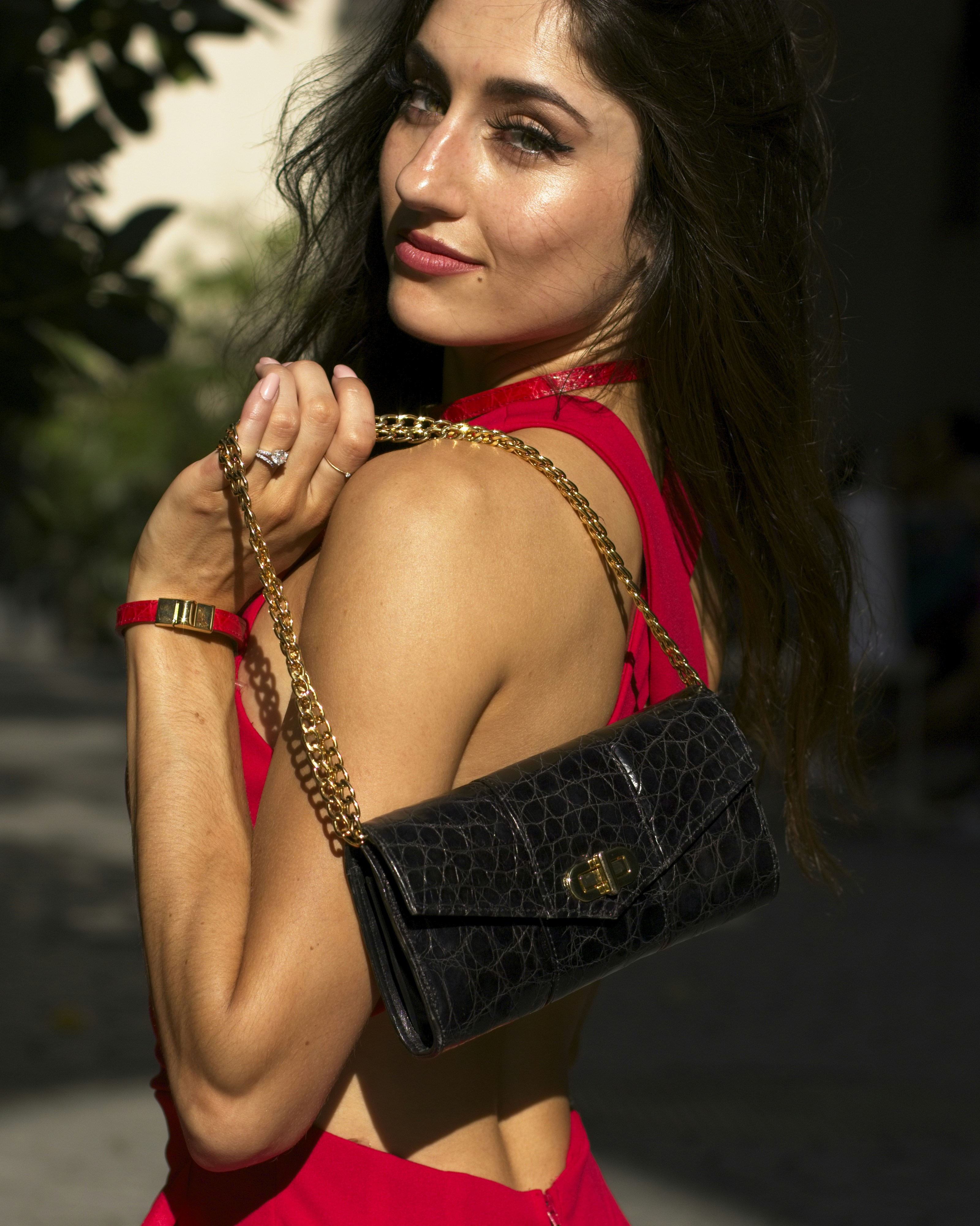 Woman in Red Dress Holding Black Croc Embossed Purse