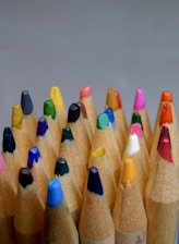 a close up of a group of colored pencils