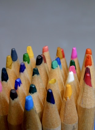 a close up of a group of colored pencils