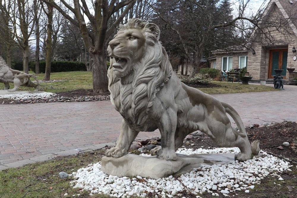 a statue of a lion sitting on top of a rock