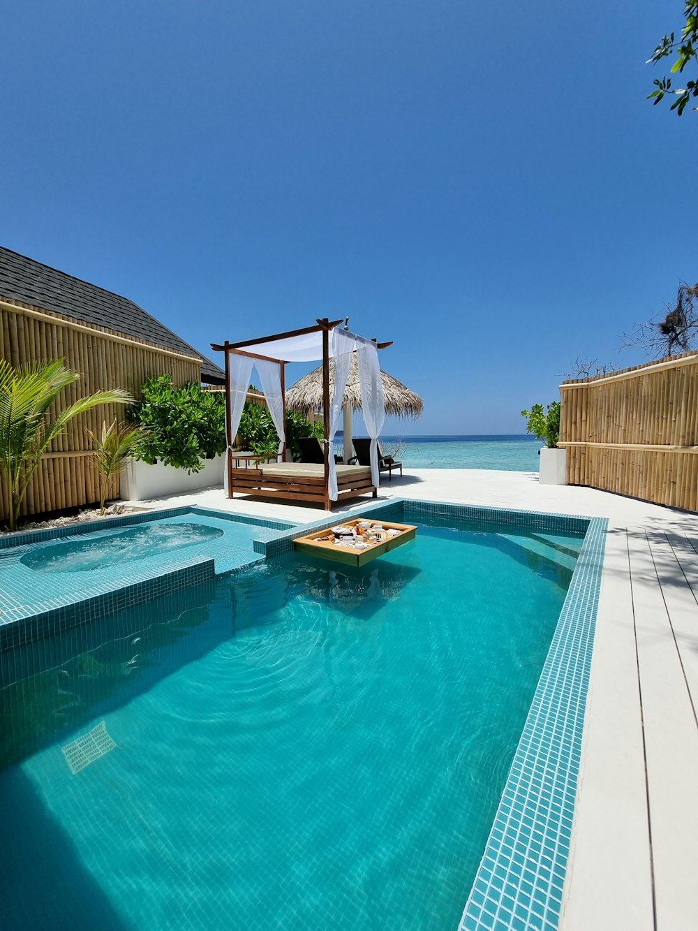 a swimming pool with a gazebo and a gazebo in the middle of it