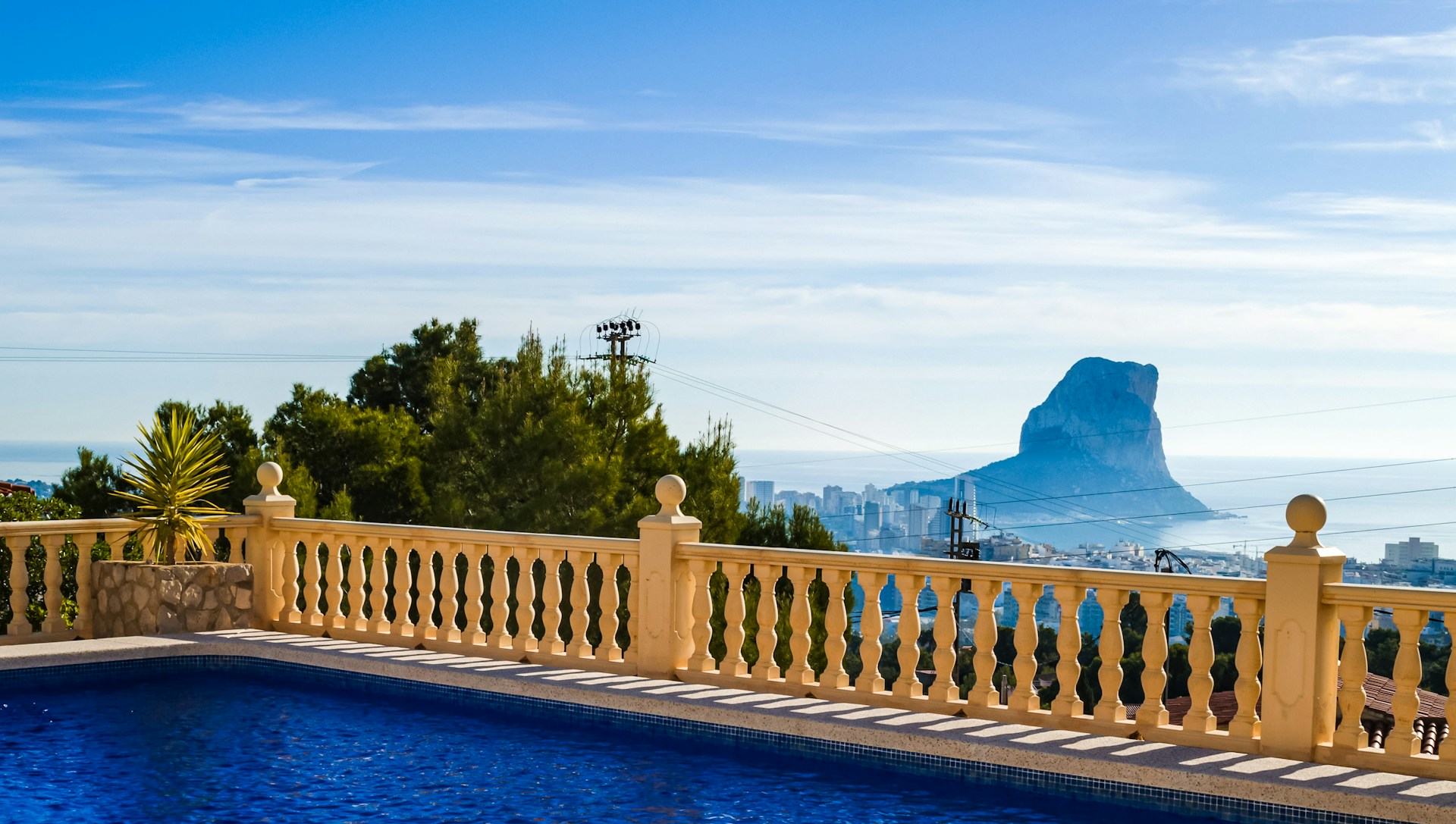 a swimming pool with a mountain in the background