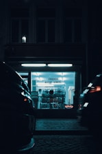a car parked in front of a building at night