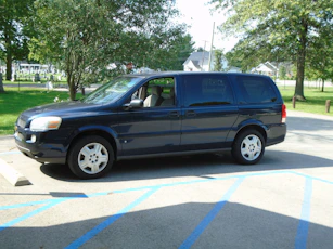 a blue van is parked in a parking lot