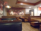 A cozy restaurant setting featuring leather menu covers on tables.